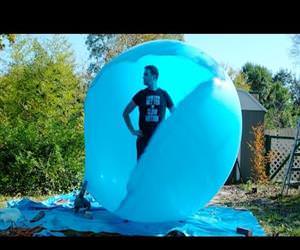 slow mo guys popping giant balloon Funny Video